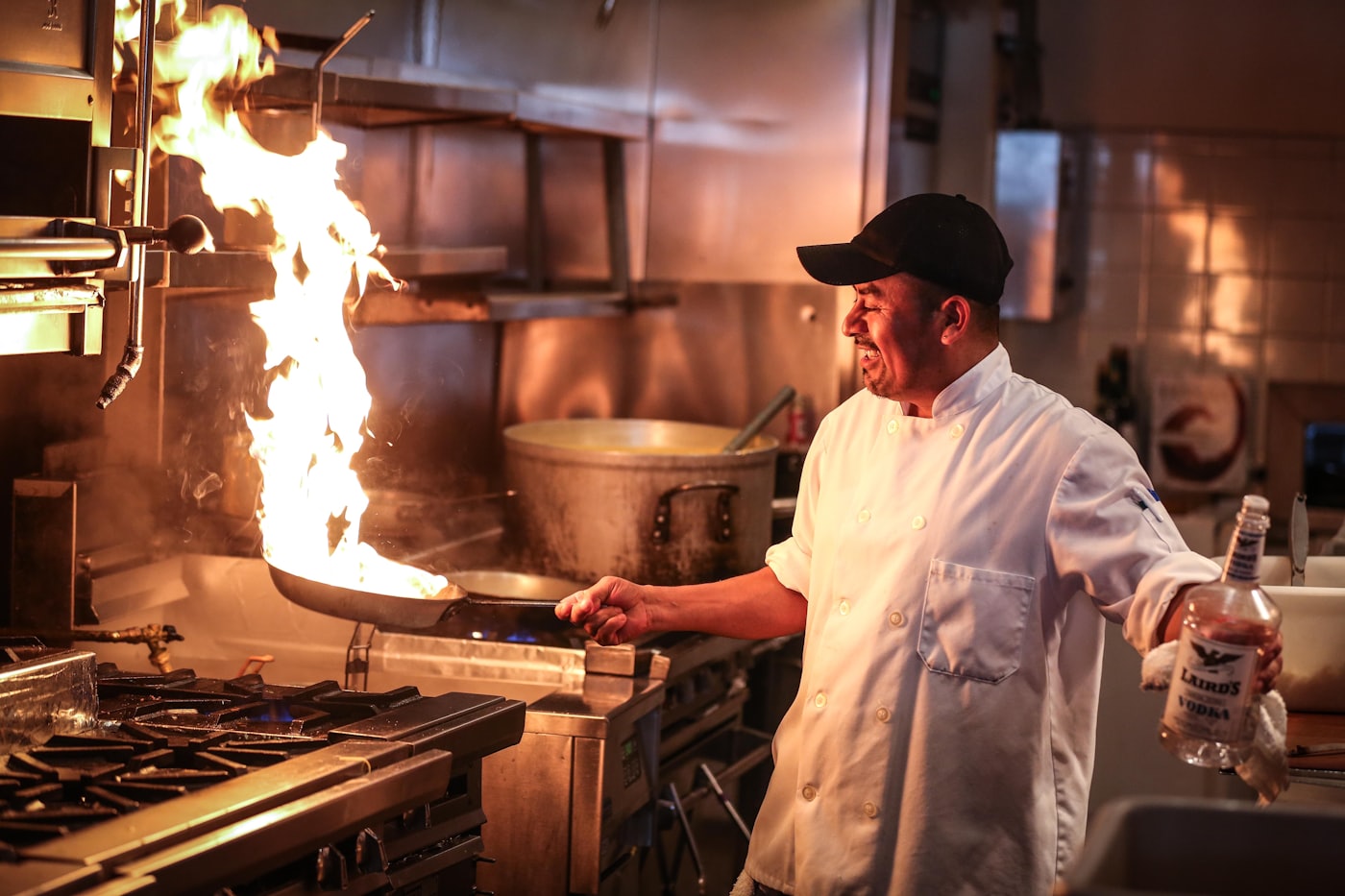 A cook working the flame in the Fuego kitchen